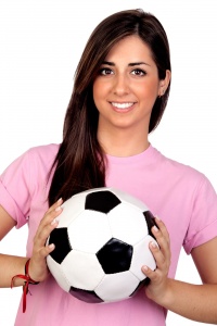 Female soccer player with a ball.