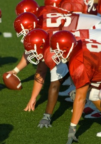 Football players on the offensive line.