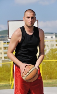 Male basketball player shooting.