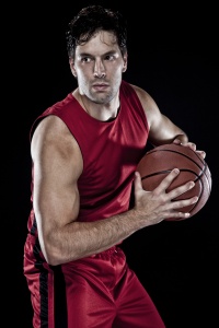 Male basketball player with ball.