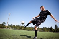 Male soccer player kicks ball