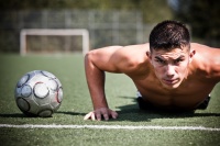 Male soccer player doing pushup